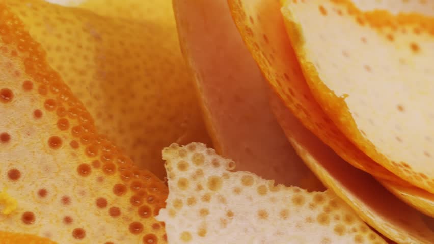bartender makes a cocktail in a glass with orange peel, barman peeling orange or lemon. 