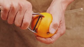 bartender makes a cocktail in a glass with orange peel, barman peeling orange or lemon.  - Powered by Shutterstock - Get 15% off with code: PIKWIZARD15