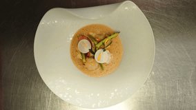 Chef Serving White Dish of Asparagus, Confit Lobster, Fresh Scallops and Fried Turnips - Powered by Shutterstock - Get 15% off with code: PIKWIZARD15