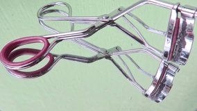 Eyelash Curler with Rubber Handles on Mirror Background - Powered by Shutterstock - Get 15% off with code: PIKWIZARD15