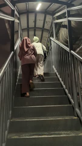 looking from the bottom of People waking up stairs