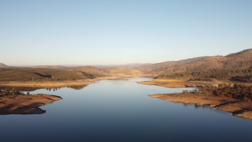 Rolling hills and tree-lined shores frame the serene waters of New Hogan Lake in this aerial view.