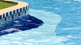 A vibrant colored swimming pool of a vintage motel resort with clear blue water and a unique design with curved green and orange borders. Ideal for architecture, leisure, and outdoor design themes. - Powered by Shutterstock - Get 15% off with code: PIKWIZARD15