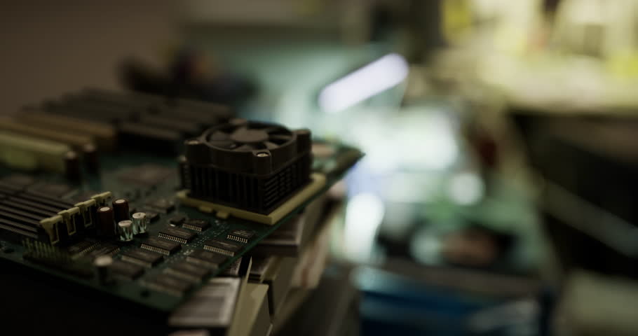 A detailed view of a computer motherboard showcasing various electronic components. The workspace is softly illuminated, hinting at ongoing repairs or upgrades.