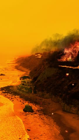 Flames consume the dry vegetation along the coastline in Los Angeles County. Vertical video