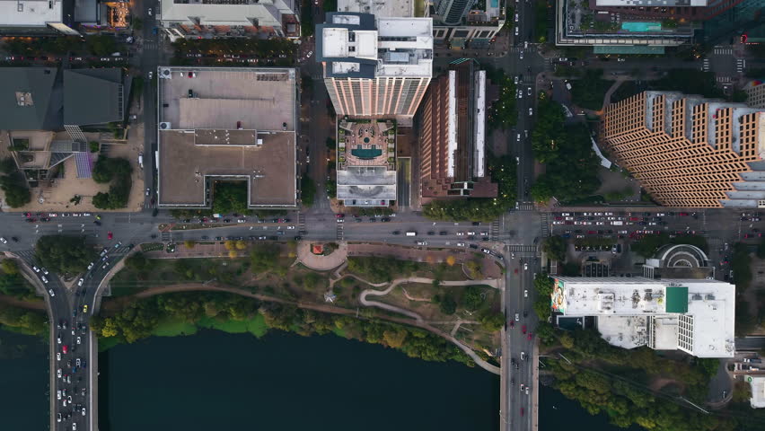 Birds eye aerial over city streets of downtown Austin, sunny evening in TX, USA