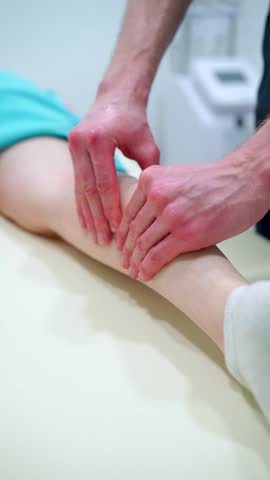 A woman is getting a massage on her legs.