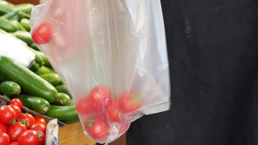 A Plastic Bag Filled with Fresh Cherry Tomatoes for Sale at a Market