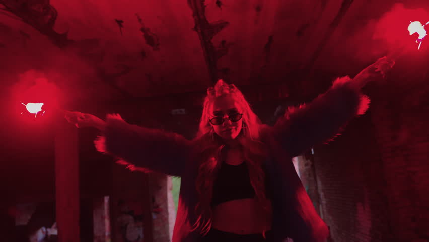 dark room. girl in blue fur coat lights flare. flare burns red. girl with flare. trend and fashion
