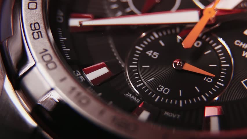 Ticking Clock face with moving hands on a quartz watch with chronograph