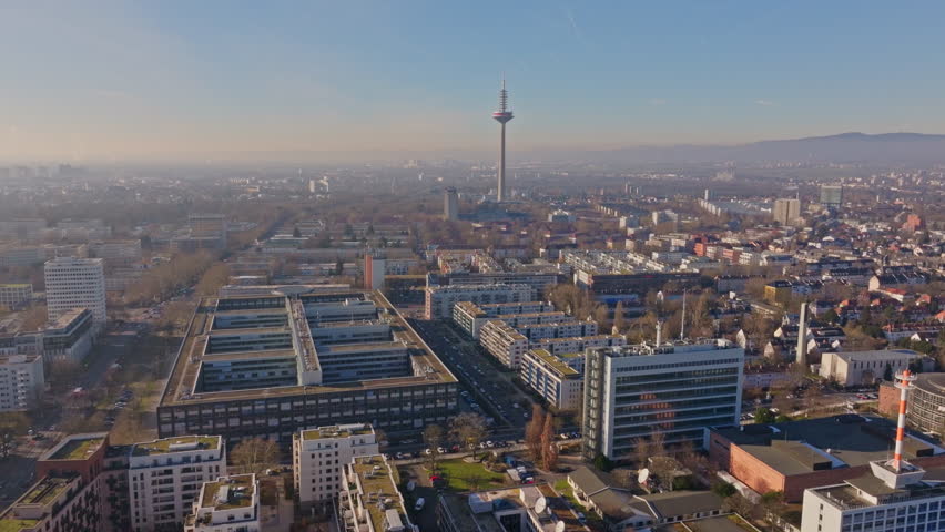 Aerial view of Frankfurt city skyline, iconic Europaturm telecommunications tower, surrounded by commercial and residential buildings and streets