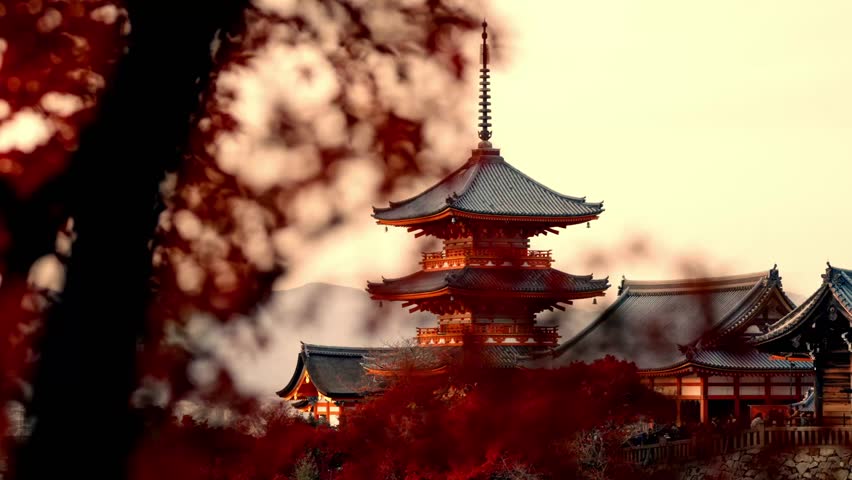 A mesmerizing view of Kiyomizu-dera Temple in Kyoto, Japan, bathed in the golden hues of sunset and surrounded by vibrant red autumn foliage.