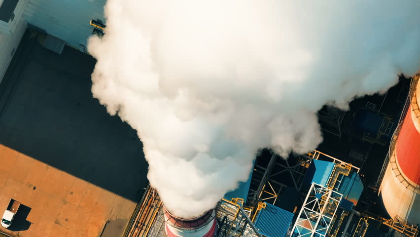 Coal power plant emits thick smoke, contributing to air pollution during peak operation hours