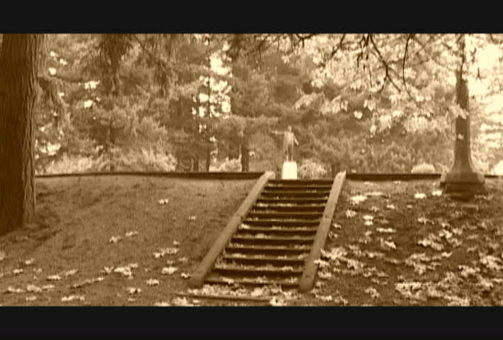 Edited clips of man running in park and grabbing a US Quarter off stone stairs,