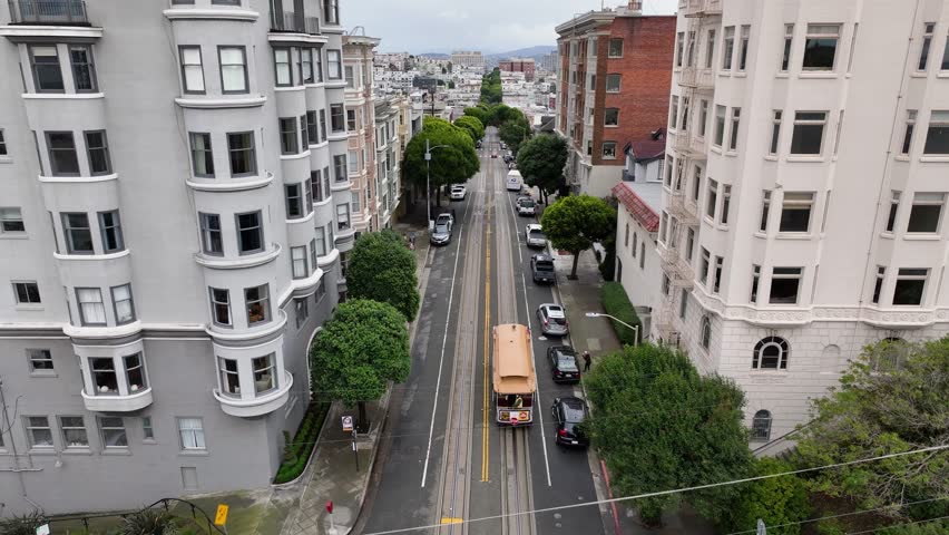 Historic San Francisco streetcar rolls through Hyde Street on a cloudy day