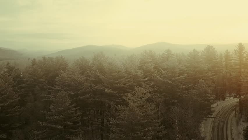snow covered winter landscape Aerial in Adirondacks, New York, New England, USA drone footage