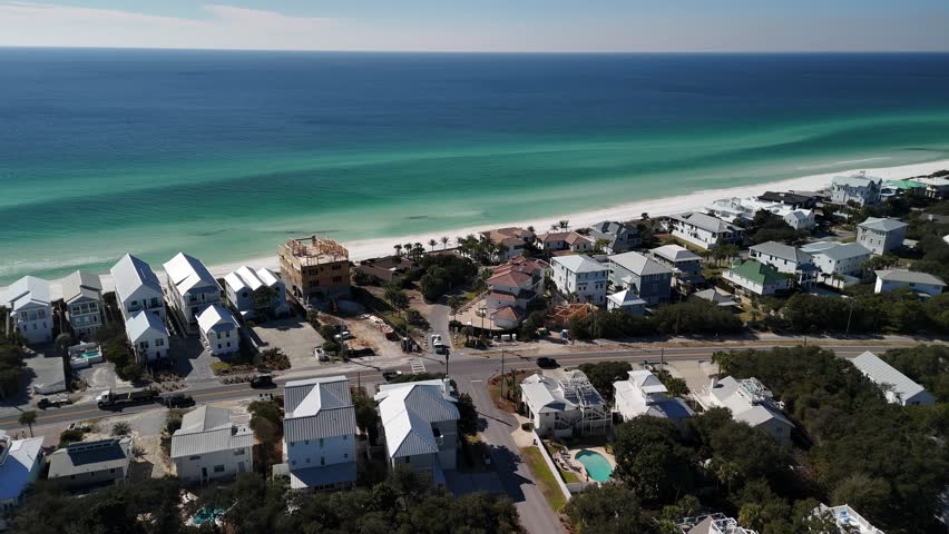 Luxury homes and condos along the Gulf Coast near Laguna Beach at Panama City Beach. White sands, Highway 30A, and summer sunshine illustrate the American dream of coastal living in Northwest Florida
