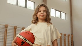 Caucasian little girl school sport playing winner game basketball schoolgirl physical education holding ball lesson pupil champion child gym training posing student workout daughter European kid adopt - Powered by Shutterstock - Get 15% off with code: PIKWIZARD15