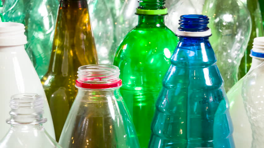 Plastic Bottles for Recycling. Footage Looped. A large group of plastic bottles of various colors and sizes slowly rotates in front of the camera close up