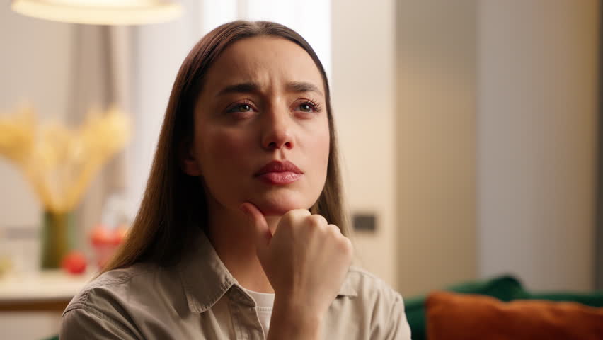 Portrait at home thoughtful pensive worried anxiety Caucasian woman female lady girl girlfriend homeowner thinking solution difficult decision hesitate unsure planning indoors in apartment puzzled