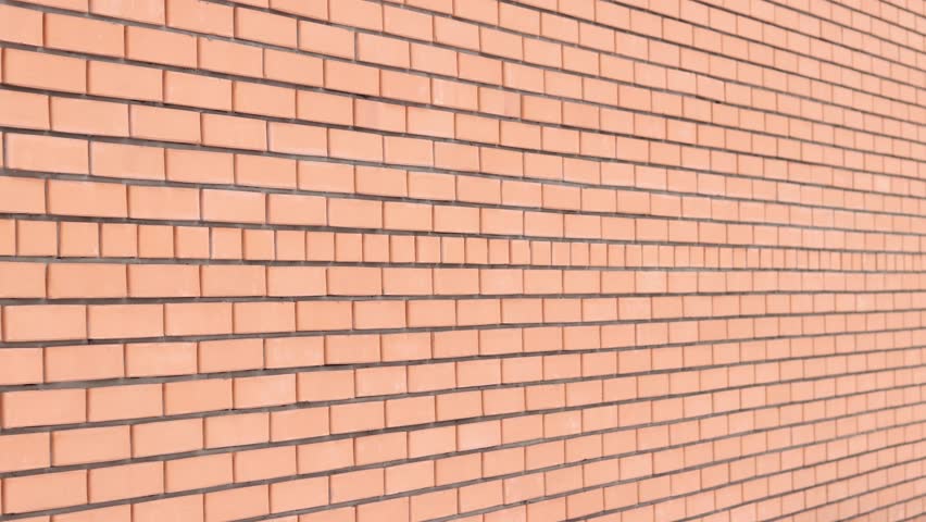 Brick wall texture, background. Orange brick wall background. Construction concept, outdoor buildings, garage or house. Wall with classic checkerboard pattern and visible joints