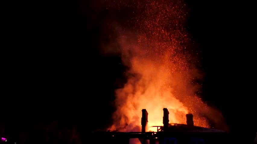 A big fire burns down the house. A fiery tragedy, The building is burning from the inside, flames are everywhere, complete destruction by fire.