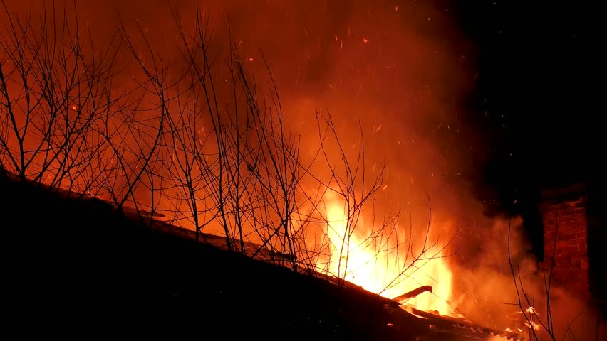 A big fire burns down the house. A fiery tragedy, The building is burning from the inside, flames are everywhere, complete destruction by fire.