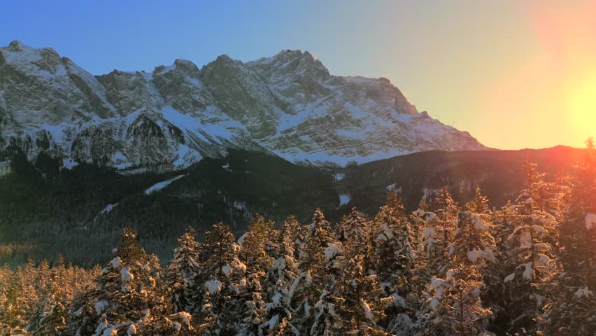 Breathtaking aerial view over snow-covered treetops in Germanys Bavarian Alps, showcasing Zugspitze massif. Zugspitze Gipfel highest peak of Wetterstein Mountains and highest mountain in Germany. 