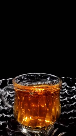 Slow Motion Shot of Droplets Falling into the Glass in a Glass Bowl Vertical Video Stock Footage 1080