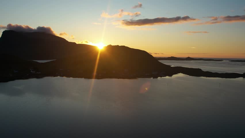 Explore Norway's Lofoten Islands through high-resolution 4K aerials. Dramatic mountain landscapes, raw nature, and cinematic views await. stock footage to elevate your visuals. midnightsun and sunset