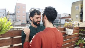 Gay couple sharing intimate moments on urban balcony - Powered by Shutterstock - Get 15% off with code: PIKWIZARD15