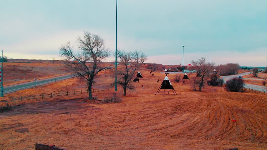 Colorado’s welcome center rest area, featuring teepee displays with passing trucks on I-80 highway
