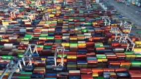 Shipping port with colorful containers. Logistics and distribution theme. Animation of relevant words overlayed blurred aerial footage. - Powered by Shutterstock - Get 15% off with code: PIKWIZARD15