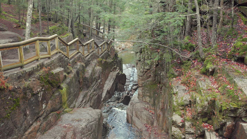 Discover the enchanting and breathtaking beauty of Crawford Notch Park in New Hampshire, where you can experience a stunning display of fall colors and enjoy the tranquil serenity of its waterways