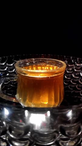 Super Slow Motion Shot of Tea Droplets Spilling While Pouring Vertical Video Stock Footage 1080