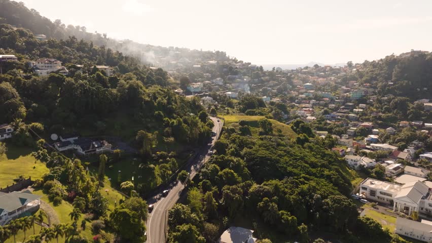 Aerial drone shot of city in Kingstown St. Vincent and the Grenadines hillside neighborhoods in the tropical rain forest