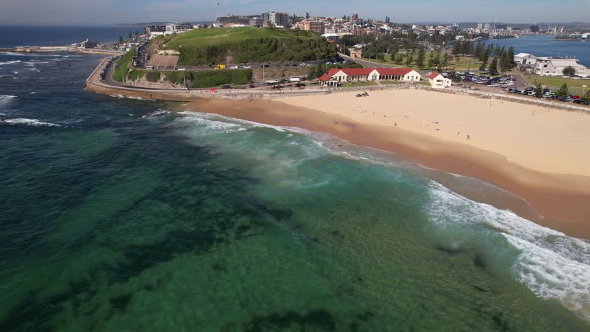 Uncrowded Nobbys Beach And Pavilion On Sunny Day In Summer In New South Wales, Australia. aerial shot