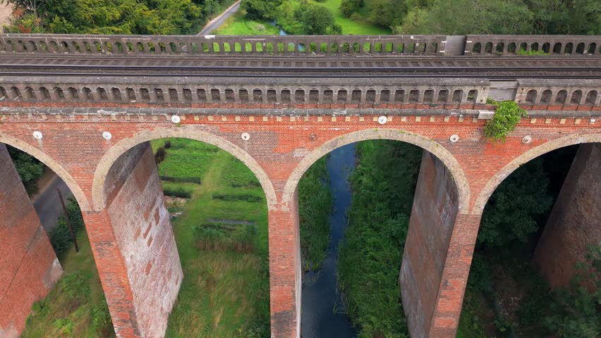 Aerial slow descend close-up view, spanning arches, bridge construction