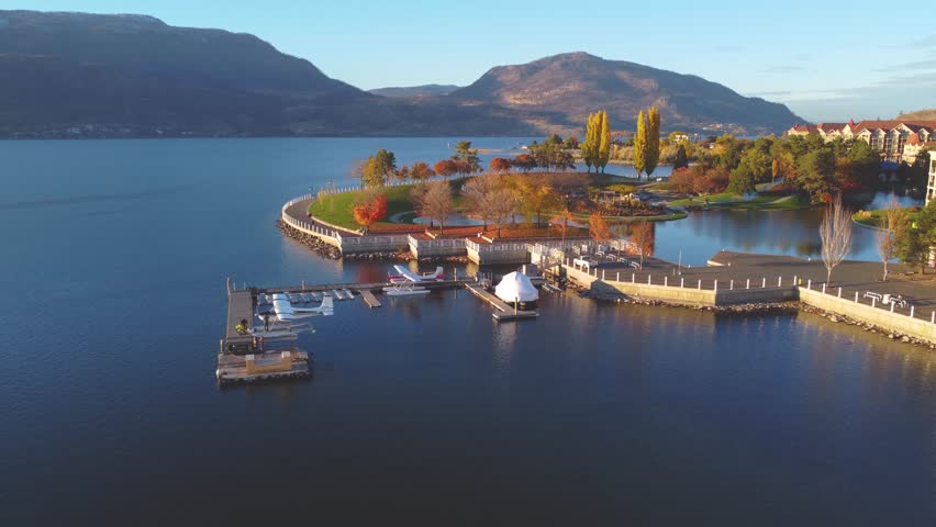 Downtown Waterfront, Kelowna, BC, Canada. Panorama Calm Okanagan Lake Landscape. British Columbia Interior in the Fall Autumn Season with Colourful Trees. Evening Sunset, City Park Walking Path