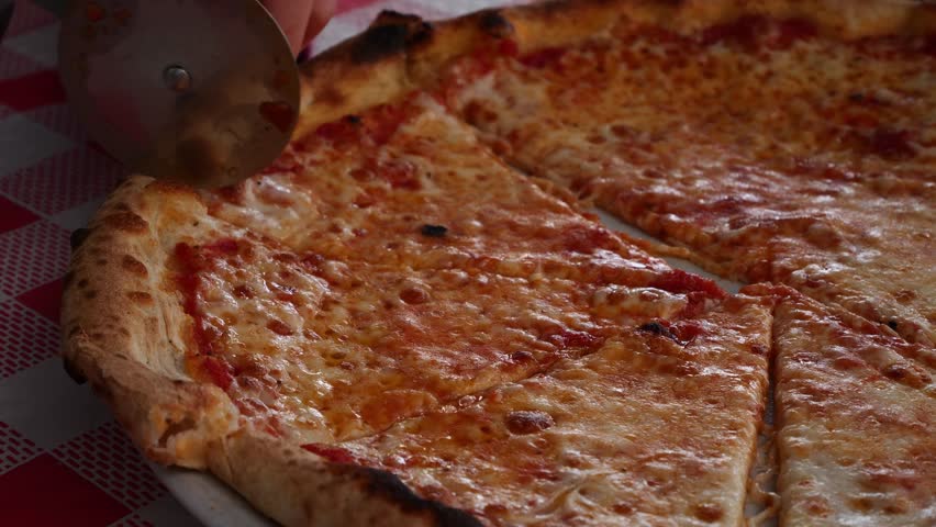 Child battling to cut a slice of pizza. Slow motion x0,5