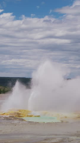 A stunning and mesmerizing geyser erupts dramatically in Yellowstone National Park, beautifully showcasing the incredible natural beauty and geothermal activity found in the wilds of Wyoming