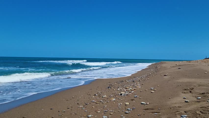 Panning shot of a wild, empty, and untouched beach in Algeria