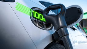An electric vehicle charging high-voltage energy at an EV charging station replenishes its battery using direct current (DC) power delivered through a charging cable to the vehicle's onboard battery - Powered by Shutterstock - Get 15% off with code: PIKWIZARD15