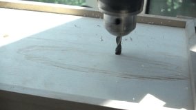 Slow motion close up of a drill about to pierce through a white wooden board with natural sunlight casting a shadow on the surface. - Powered by Shutterstock - Get 15% off with code: PIKWIZARD15