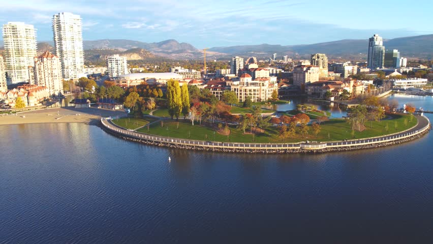 Downtown Waterfront, Kelowna, BC, Canada. Panorama Calm Okanagan Lake Landscape. British Columbia Interior in the Summer Season. Evening Sunset, City Park Walking Path