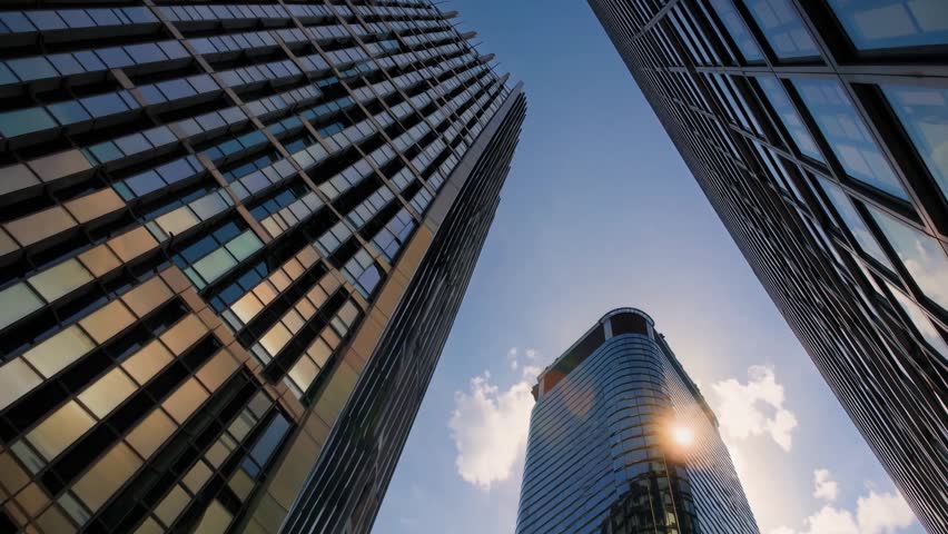 A stunning low-angle view of towering skyscrapers in a bustling financial district, symbolizing power, ambition, and modern business growth. 