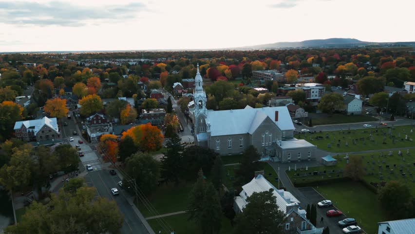 aerial circular shot around St Matthieu Church in Beloeil, montreal area in Quebec province during fall season in Canada