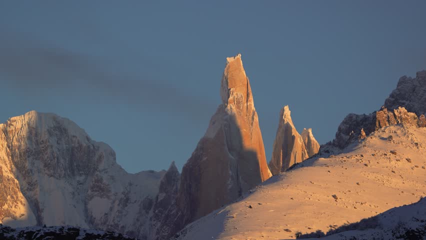 Cloud slowly cover and uncover Cerro Torre and Adela Mountain range in Patagonia, El Chalten, Argentina, in winter. Static zoomed in view