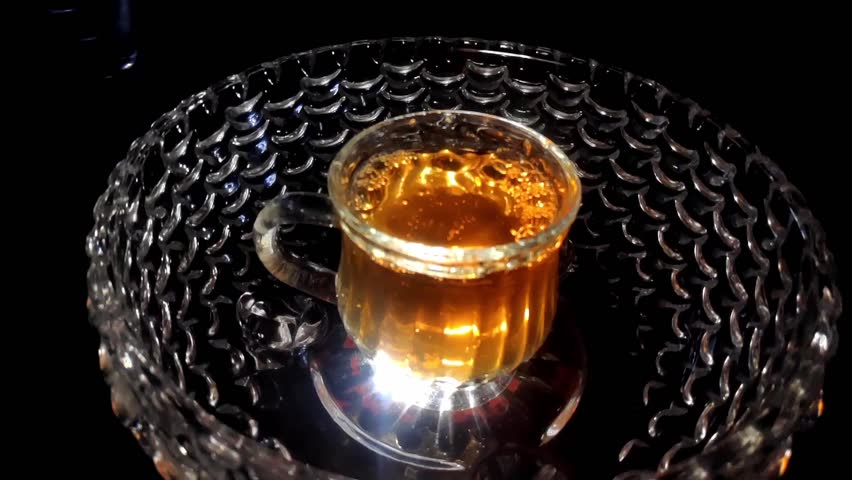 Slow Motion Shot of Tea Pouring into the Glass in a Glass Bowl Video Stock Footage 1080