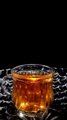 Slow Motion Shot of Droplets Falling into the Glass and Spilling Out the Bowl Vertical Video Stock Footage 1080